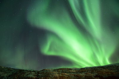 Scenic view of landscape against sky at night