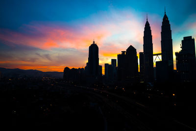 Cityscape against sky at dusk