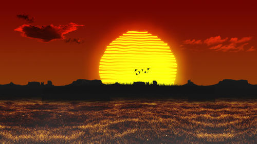 Scenic view of silhouette field against orange sky