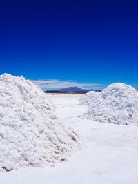 Scenic view of snowcapped mountain against blue sky