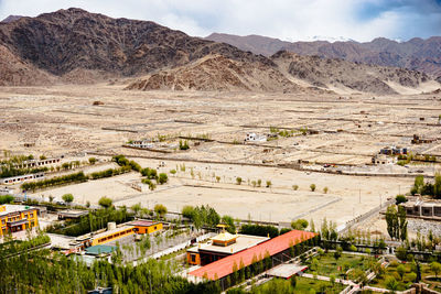 High angle view of townscape and mountains against sky