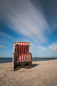 Lifeguard hut on beach against sky