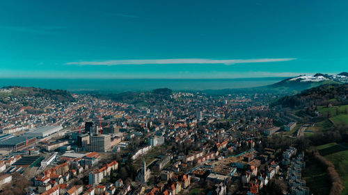 High angle view of townscape against blue sky