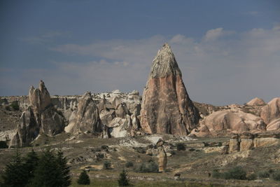 Rock formations on landscape against sky