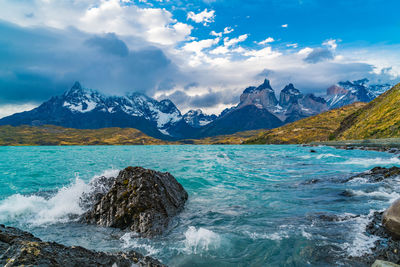 Scenic view of sea and mountains against sky