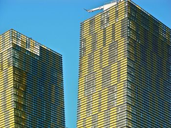 Low angle view of modern buildings against clear blue sky