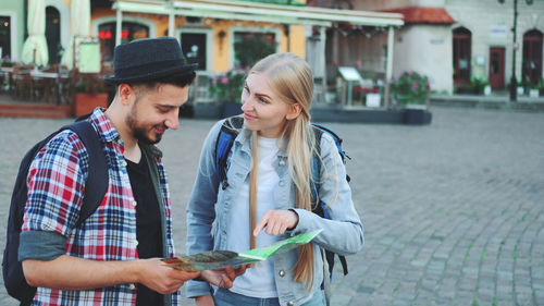 Young couple holding hands in city