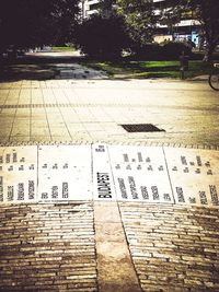 High angle view of text on footpath