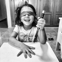 Portrait of smiling girl holding camera