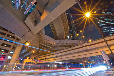 Low angle view of illuminated bridge at night