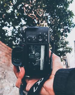 Midsection of person holding camera