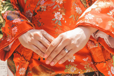 Midsection of woman wearing kimono