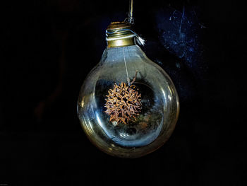 Close-up of illuminated light bulb on table