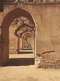 Women in corridor of old building