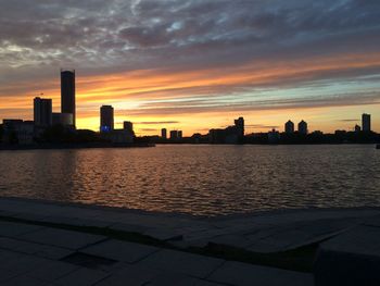 City at waterfront during sunset