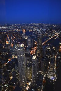 Aerial view of illuminated cityscape against sky at night