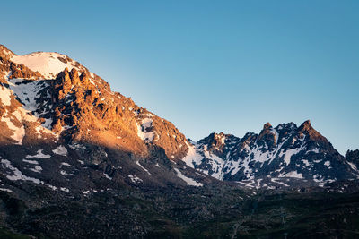 Scenic view of snowcapped mountains against clear sky