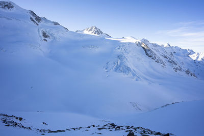 Scenic view of snow covered mountains against sky