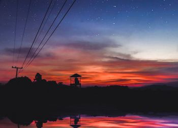 Scenic view of lake against orange sky