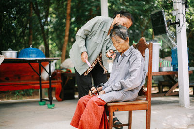 Portrait of woman sitting on chair