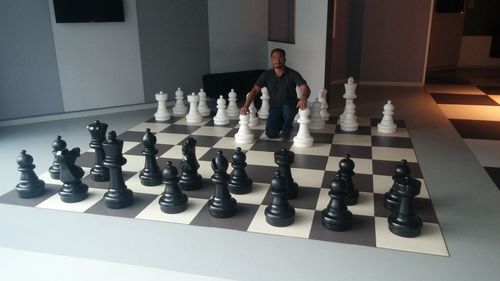 Full frame shot of men playing on chess board