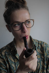 Portrait of woman holding eyeglasses