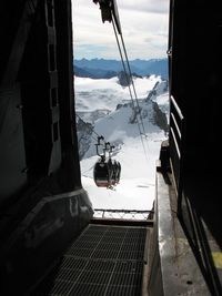 Close-up of ski lift against sky