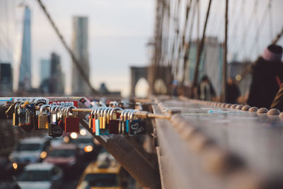 Close-up of love locks hanging on railing at brooklyn bridge