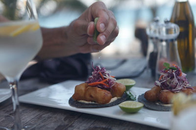 Close-up of person preparing food on table