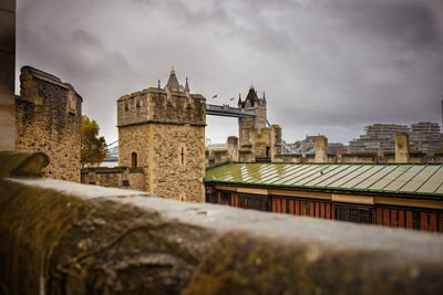 Old building in city against cloudy sky