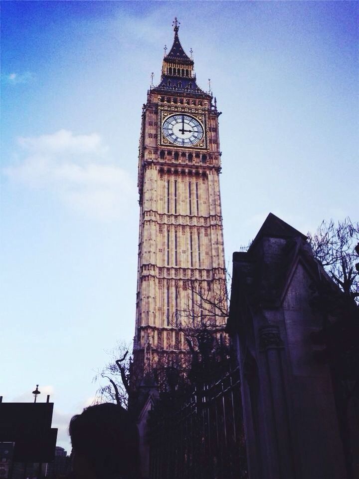 architecture, built structure, building exterior, low angle view, tower, tall - high, history, sky, clock tower, famous place, travel destinations, clear sky, religion, place of worship, tourism, tree, travel, blue, spirituality, international landmark