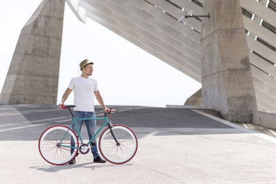 Full length of man standing with bicycle