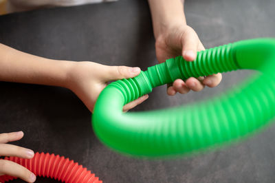 Anti stress sensory pop tube toys in a children's hands. a little kids plays with a poptube toy