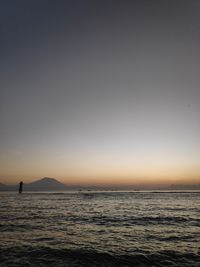 Scenic view of sea against clear sky during sunset