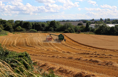 Hay bales on field against sky