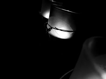Close-up of illuminated lantern over black background