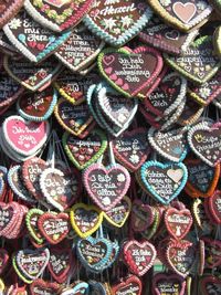 Full frame shot of heart shape decorations with text for sale in market