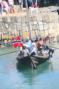 People sitting on boat in canal