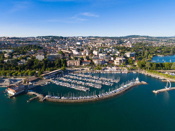 High angle view of buildings by sea against sky