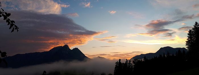 Scenic view of silhouette mountains against sky at sunset