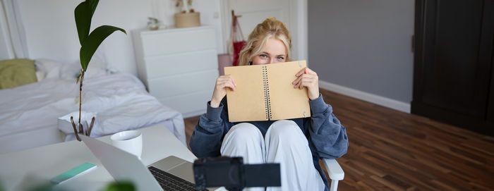 Portrait of young woman holding gift box