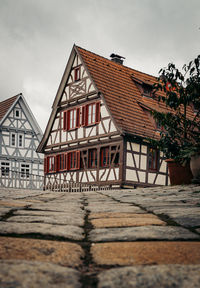 Houses by street against sky in city