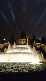 View of fountain in city at night