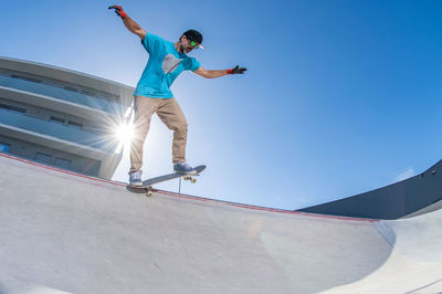 Low angle view of man jumping on staircase