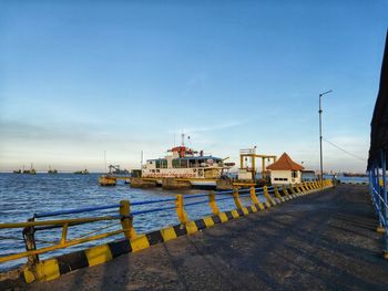 Pier over sea against blue sky