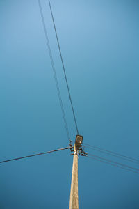 Low angle view of street light against clear blue sky