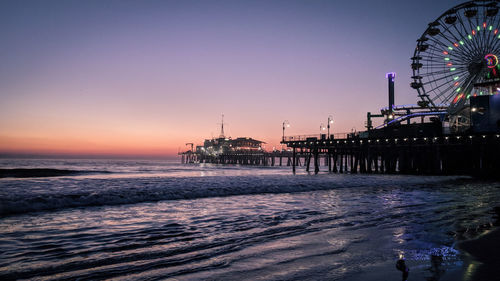 Scenic view of beach against clear sky during sunset