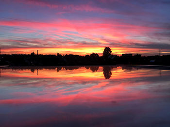 Scenic view of lake against romantic sky at sunset