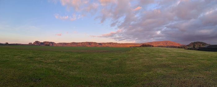 Scenic view of field against sky during sunset