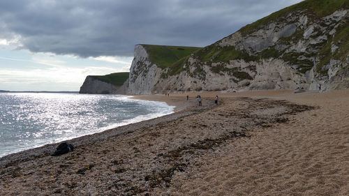 Scenic view of people on a beach